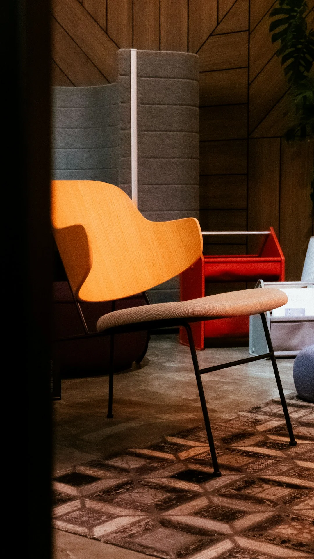 Three volunteers organizing donation boxes with clothes and food items in a community center.
